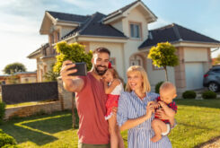 family in front of house